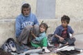 Beggar family begs for money from a passerby in Leh. India Royalty Free Stock Photo