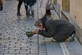 Beggar kneeling begging in the Old Town.