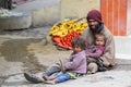 Beggar man with children begging on the street in Leh, Ladakh. India