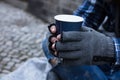 Beggar Holding Disposable Cup