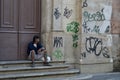 beggar sitting next to church