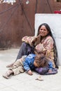 Beggar woman with a child begging in Buddhist temple in Leh, Ladakh. India