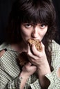 Beggar woman eating bread