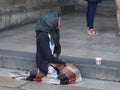 Beggar woman on the steps of Lisbon`s Lisboa cathedral