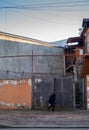 beggar woman walks against the wall. Local resident in the old area. The household. The courtyard is old in Batumi