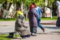 Kaluzhskiy region, Russia - July 2019: Beggars begging near an Orthodox church