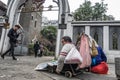 Beggar in front of the church