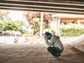 The beggars sat under the bridge with both hands holding to the head