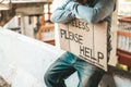 Beggars sit on barriers with homeless Please help messages