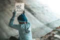 Beggars sitting under the bridge with a sign, help please Royalty Free Stock Photo