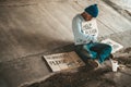Beggars sitting under the bridge with a sign, help please Royalty Free Stock Photo