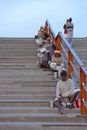 Beggars waiting for alms sitting on stairs Royalty Free Stock Photo