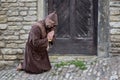 The begging monk in front of the monastery`s door.