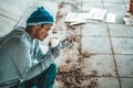 Begging under the bridge with a cup containing coins and instant noodles Royalty Free Stock Photo