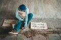 Begging under the bridge with a cup containing coins and instant noodles Royalty Free Stock Photo