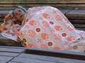 Begging woman sleeping outside Royalty Free Stock Photo