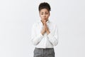 Begging you for mercy. Portrait of upset cute african-american in white shirt and pants, holding hands in pray near Royalty Free Stock Photo