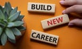 Begin new career symbol. Concept word Begin new career on wooden blocks. Businessman hand. Beautiful orange background. Business Royalty Free Stock Photo