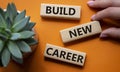 Begin new career symbol. Concept word Begin new career on wooden blocks. Businessman hand. Beautiful orange background. Business Royalty Free Stock Photo