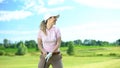 Beginner female golf player holding club and smiling, rejoicing shot, victory