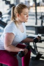 Beginner girl exercising in fitness gym with dumbbells Royalty Free Stock Photo