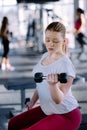 Beginner girl exercising in fitness gym with dumbbells Royalty Free Stock Photo