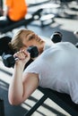 Beginner girl exercising in fitness gym with dumbbells Royalty Free Stock Photo