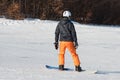 Beginner snowboarder in a sunny day