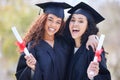 This is the beginning of anything you want. Portrait of two young women holding their diplomas on graduation day. Royalty Free Stock Photo