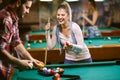 Beginning billiard game - man and woman flirting while playing snooker