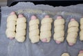 The beginning of cooking sausages in the dough in the home kitchen in the oven. Royalty Free Stock Photo