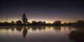 The beginning of dawn on the lake on a starry night in a clear sky comet Neowice