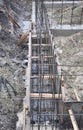 The beginning of house foundation construction: digging deep trenches for concrete foundation and installing the rigid structure