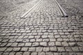 Cobbled paving road with beginning of rails - beginning / end of road.