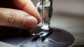 Beginning of sewing process. Woman`s hands pulling threads through loop needle and presser foot. Close up view. Royalty Free Stock Photo