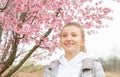 Beginning of Spring. Beautiful woman enjoying nature blooming tree Royalty Free Stock Photo