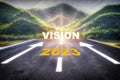 Road to 2023 vision on asphalt road surface with arrow sign on the mountain background Royalty Free Stock Photo
