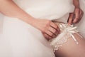 bride wears a wedding garter Royalty Free Stock Photo