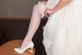 Beginning of the wedding day. the bride wears a wedding garter Royalty Free Stock Photo