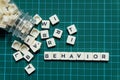 Behavior word made of square letter word on green square mat background. Royalty Free Stock Photo