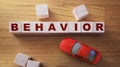 Behavior Word In Wooden Cube and red toy car. Child behavior microagression self control concept Royalty Free Stock Photo