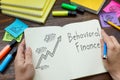 Behavioral finance is shown on the business photo using the text