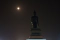 Behind of big buddha statue in full moon night