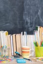 From behind the books you can see a school board. A lot of school aids are arranged on the desk Royalty Free Stock Photo