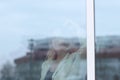 From behind the glass. young business woman looking out the office window Royalty Free Stock Photo