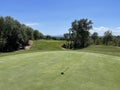 Behind the green shot of a golf hole looking back down the fairway from the flag Royalty Free Stock Photo