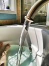 Spout running water into a bathroom jacuzzi Royalty Free Stock Photo