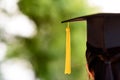 Behind photo of university graduate wears gown and black cap, ye Royalty Free Stock Photo