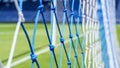 Behind the ropes of the outdoor soccer field goal net, football goal background Royalty Free Stock Photo