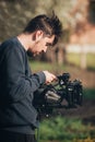 Behind the scene. Cameraman shooting film scene with his camera Royalty Free Stock Photo